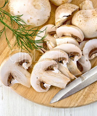 Champignons raw on board with knife