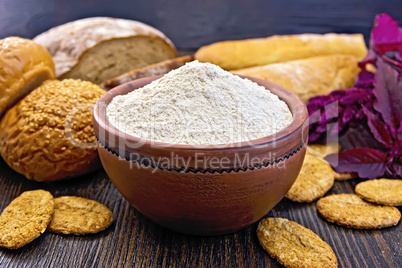 Flour amaranth in clay bowl with bread on board