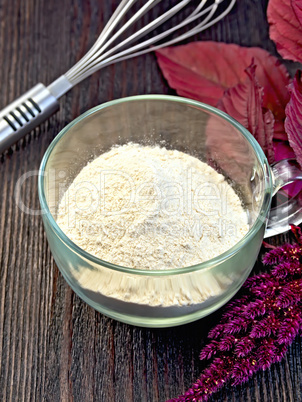 Flour amaranth in glass cup on board with mixer