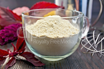 Flour amaranth in glass cup on board