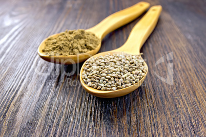 Flour and seed of hemp in spoon on board