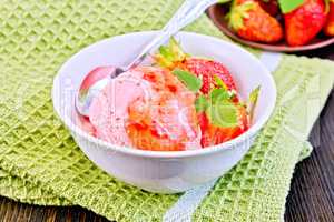 Ice cream strawberry with syrup and mint in bowl on board