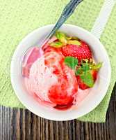 Ice cream strawberry with syrup in bowl on board