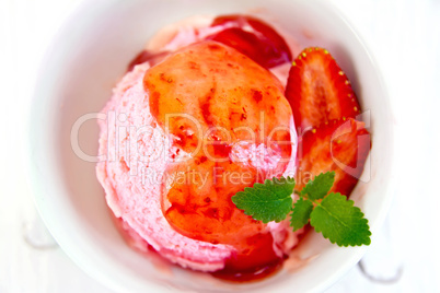 Ice cream strawberry with syrup on board top