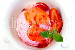 Ice cream strawberry with syrup on board top