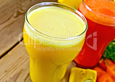 Juice pumpkin and carrot on wooden board