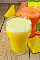 Juice pumpkin and carrot with vegetables on wooden board