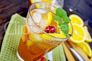 Lemonade with cherry in glassful on board