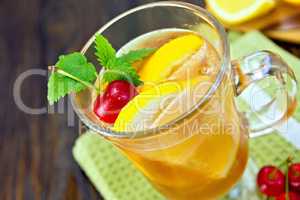 Lemonade with cherry in wineglass on board