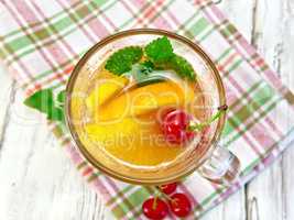 Lemonade with cherry in wineglass on board top