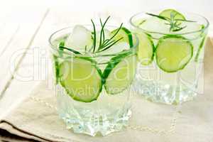 Lemonade with cucumber and rosemary in two glassful on napkin