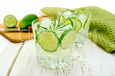 Lemonade with cucumber and rosemary in two glassful on board