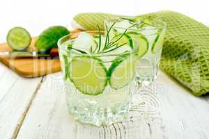 Lemonade with cucumber and rosemary in two glassful on board