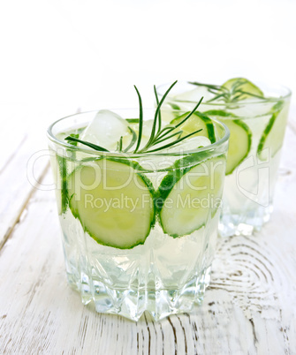 Lemonade with cucumber and rosemary in two glassful on table