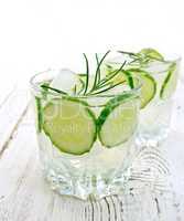 Lemonade with cucumber and rosemary in two glassful on table