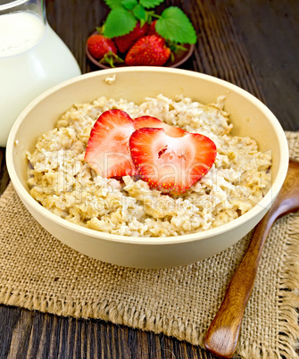 Oatmeal with strawberry on dark board