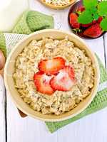 Oatmeal with strawberry on light board top