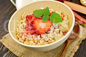 Oatmeal with strawberry-rhubarb sauce on board