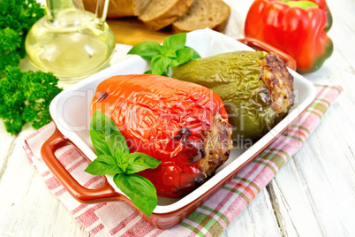 Pepper stuffed meat in brown roaster with basil
