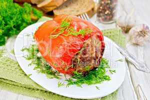 Pepper stuffed meat with dill in plate on board