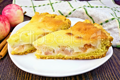 Pie apple with sour cream and cinnamon on dark board