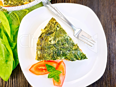 Pie celtic with spinach and tomato in plate on table top