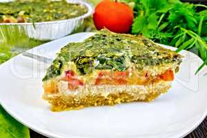 Pie celtic with spinach and tomatoes on board