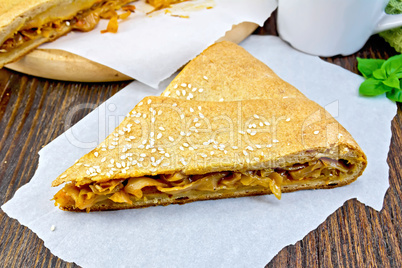 Pie with cabbage and sesame on parchment