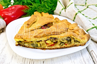 Pie with cabbage and sorrel in plate on board