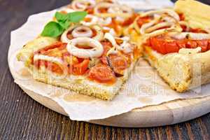 Pie with onions and tomatoes on paper