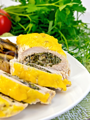 Roll chicken with champignons and spinach on board