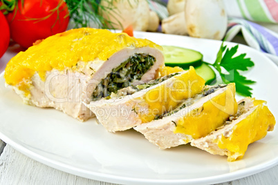 Roll chicken with spinach and cucumber on board