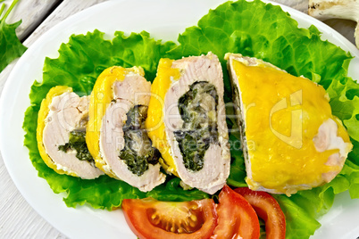 Roll chicken with spinach and lettuce on board