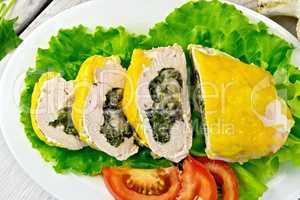 Roll chicken with spinach and lettuce on board