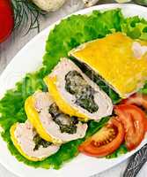 Roll chicken with spinach and tomatoes on board
