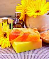Soap homemade and oil with calendula on bamboo