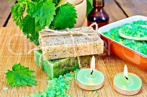 Soap homemade with nettles in mortar on board