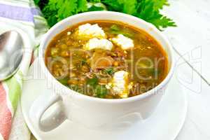 Soup lentil with spinach and feta on light board