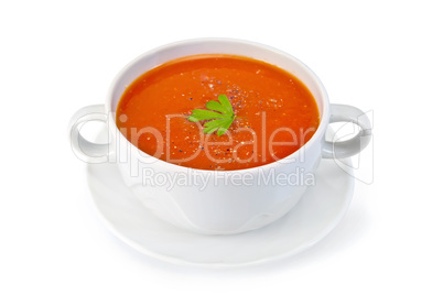 Soup tomato with parsley in white bowl on saucer