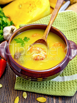 Soup-puree pumpkin with prawns and mushrooms on board