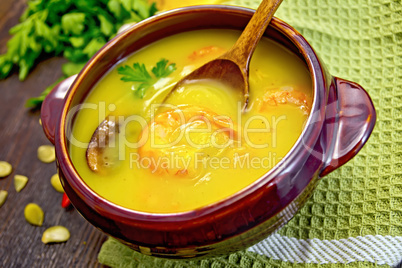 Soup-puree pumpkin with prawns and mushrooms on napkin