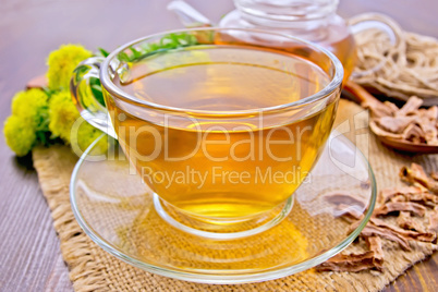 Tea of Rhodiola rosea in glass cup on board