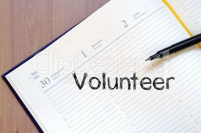 Volunteer write on notebook