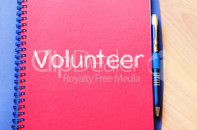 Volunteer write on notebook