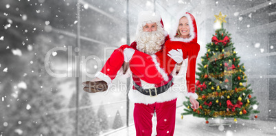 Composite image of santa and mrs claus smiling at camera
