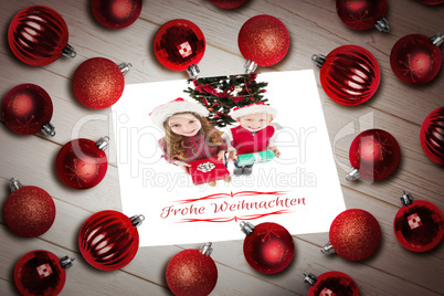 Composite image of christmas baubles on table