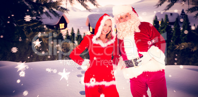 Composite image of santa and mrs claus smiling at camera