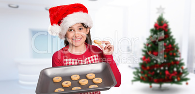 Composite image of festive little girl offering cookies