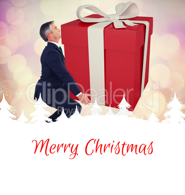 Composite image of stylish man with giant gift