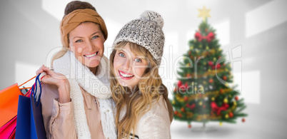 Composite image of beautiful women holding shopping bags looking